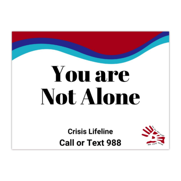Sign says, "You are not alone crisis lifeline call or text 988" with the our city cares logo and a wave of purple, turquoise, and red at the top.