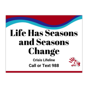 Sign says, “Life has Seasons and Seasons Change" along with the crisis lifeline that says, "Call or text 988" with the suicide prevention awareness colors and the Our City Cares Logo at the bottom.