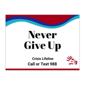 Sign says, “Never “Give Up along with the crisis lifeline that says, "Call or text 988" with the suicide prevention awareness colors and the Our City Cares Logo at the bottom.