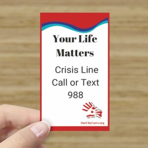 Card says, "Your Life Matters, Crisis Line Call or Text 988" along with the Our City Cares logo and suicide prevention colors.